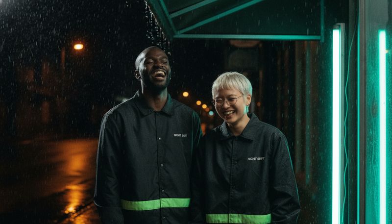 Dez and Kit under an awning in the rain